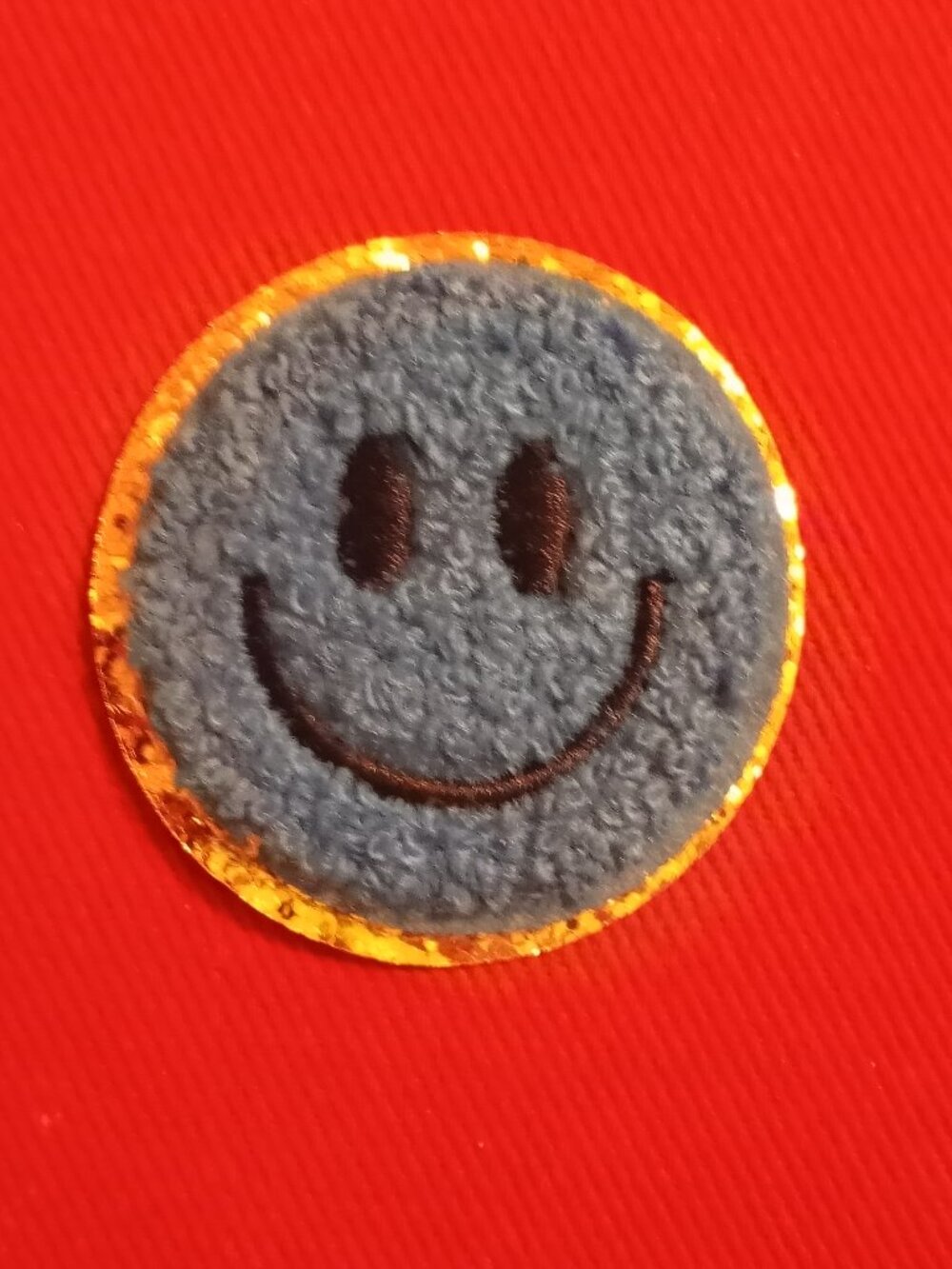 Blue smiley face chenille patch